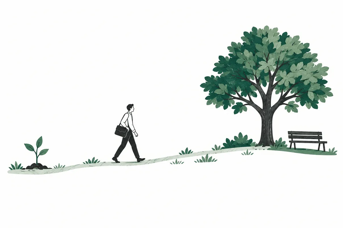 A path from a young sapling, past a person carrying a work bag, to a mature tree and a bench.